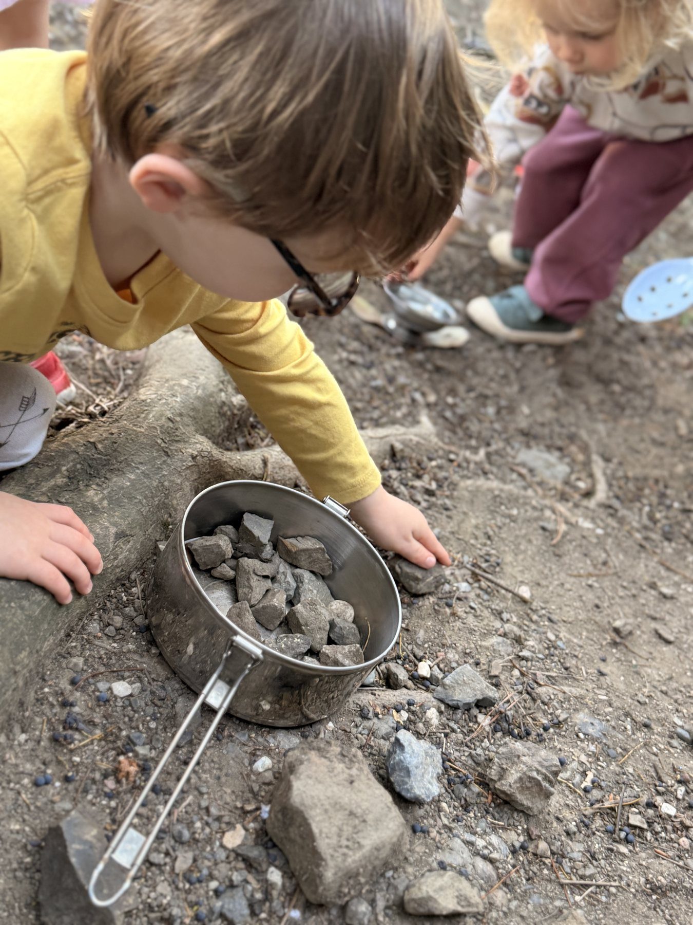 A child using natural materials in open-ended play